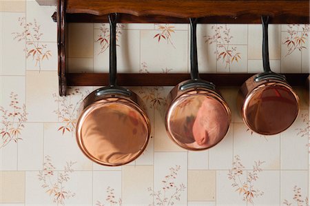 Copper pots hanging on wall rack Stock Photo - Premium Royalty-Free, Code: 632-05991389