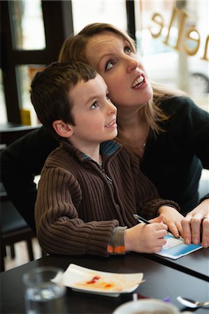 Mother and son checking results for lottery ticket Stock Photo - Premium Royalty-Free, Code: 632-05991423