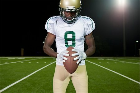 frontal view head down - Football player holding football Stock Photo - Premium Royalty-Free, Code: 632-05991458