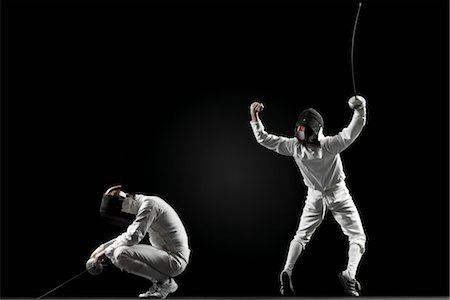 fence - Winning fencer celebrating over defeated fencer Stock Photo - Premium Royalty-Free, Code: 632-05991632