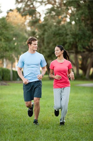 Young could jogging on grass Stock Photo - Premium Royalty-Free, Code: 632-05991738