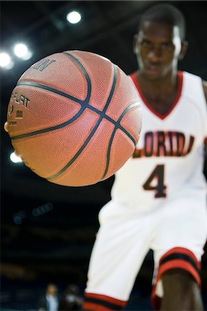 Basketball player dribbling basketball, low angle view Stock Photo - Premium Royalty-Free, Code: 632-05991863