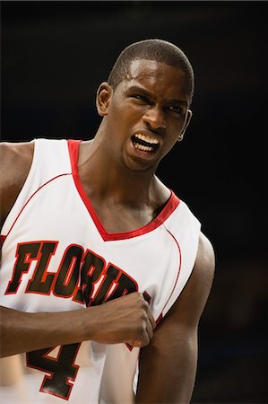 sports basketball portrait black background - Basketball player cheering Stock Photo - Premium Royalty-Free, Code: 632-05991881