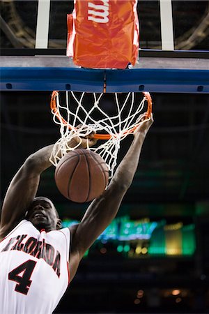 Basketball player slam dunking basketball Stock Photo - Premium Royalty-Free, Code: 632-05991959