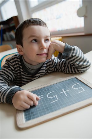 Boy solving math problem Stock Photo - Premium Royalty-Free, Code: 632-05991984