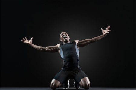 Male athlete kneeling and shouting with despair Stock Photo - Premium Royalty-Free, Code: 632-05991994