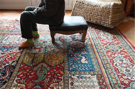 Woman sitting on ottoman in living room, low section Stock Photo - Premium Royalty-Free, Code: 632-05992093