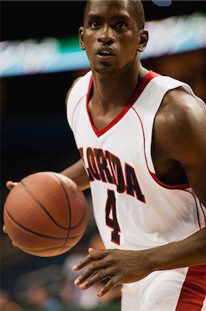 person holding a basketball - Basketball player dribbling ball Stock Photo - Premium Royalty-Free, Code: 632-05992140