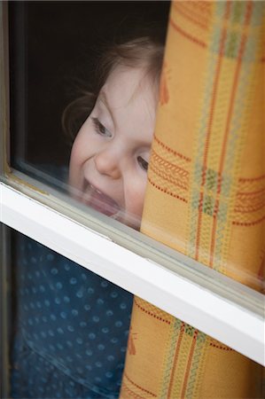 simsearch:632-05845591,k - Little girl looking through window Stock Photo - Premium Royalty-Free, Code: 632-05992253