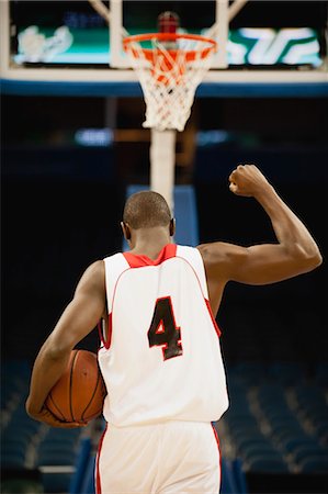 sports basketball male - Basketball with fist raised in victory, rear view Stock Photo - Premium Royalty-Free, Code: 632-05992281