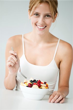 fork fruit - Young woman with fruit bowl Stock Photo - Premium Royalty-Free, Code: 632-06029353