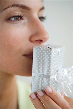 simsearch:632-06029820,k - Woman kissing wrapped gift Stock Photo - Premium Royalty-Free, Code: 632-06029365