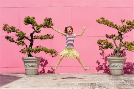 Girl jumping in air, portrait Stock Photo - Premium Royalty-Free, Code: 632-06029485