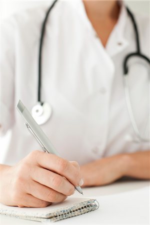 Doctor writing notes on notepad, cropped Stock Photo - Premium Royalty-Free, Code: 632-06029586