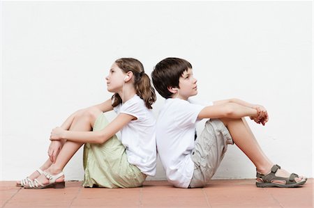 preteen girl full body - Boy and girl sitting back to back listening to music together Stock Photo - Premium Royalty-Free, Code: 632-06029670
