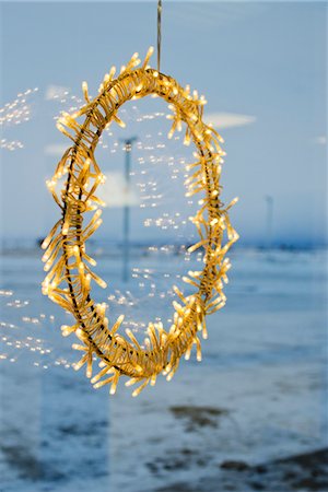 Illuminated Christmas decoration hanging in window Stock Photo - Premium Royalty-Free, Code: 632-06029721