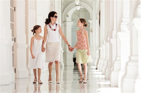 Mother and daughter walking side by side holding hands Stock Photo - Premium Royalty-Free, Code: 632-06029738