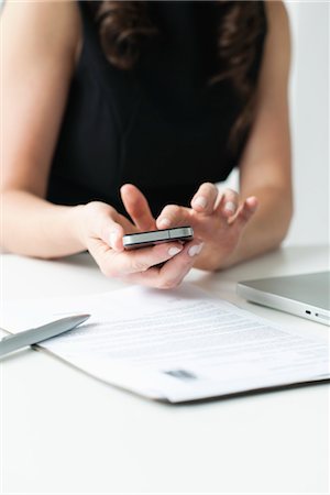 smartphone on desk - Woman using smartphone, mid section Stock Photo - Premium Royalty-Free, Code: 632-06029814