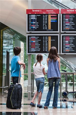 Children looking at arrival departure board, rear view Stock Photo - Premium Royalty-Free, Code: 632-06029882