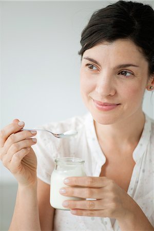 Mid-adult woman eating yogurt, portrait Stock Photo - Premium Royalty-Free, Code: 632-06029907