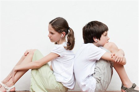 preteen sandals - Boy and girl sitting back to back listening to music together Stock Photo - Premium Royalty-Free, Code: 632-06029922