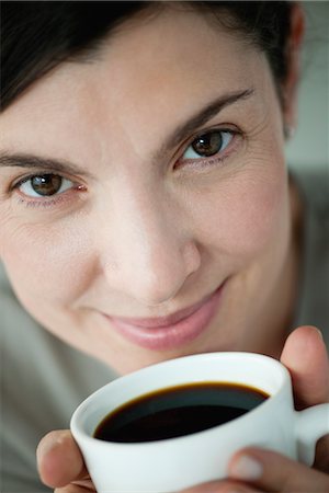 studio portrait above woman - Mid-adult woman holding cup of coffee Stock Photo - Premium Royalty-Free, Code: 632-06030011