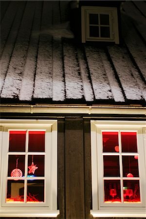 Christmas decorations hanging in window of house at night Stock Photo - Premium Royalty-Free, Code: 632-06030087