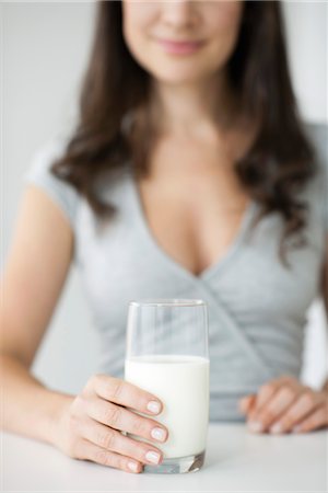 Woman holding glass of milk Stock Photo - Premium Royalty-Free, Code: 632-06030152