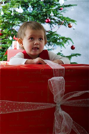 Baby girl opening large Christmas present Stock Photo - Premium Royalty-Free, Code: 632-06118117