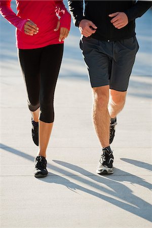 simsearch:632-06118631,k - Couple jogging side by side, low section Stock Photo - Premium Royalty-Free, Code: 632-06118113