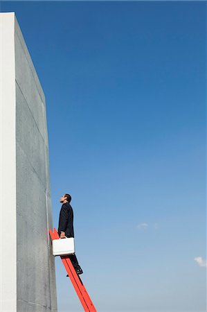 person climbing the ladder - Determined business professionals climb ladder of success despite challenges Stock Photo - Premium Royalty-Free, Code: 632-06118178