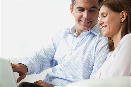 Couple looking at laptop computer together Stock Photo - Premium Royalty-Free, Code: 632-06118216