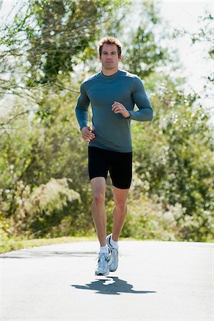 front view - Mid-adult man jogging Stock Photo - Premium Royalty-Free, Code: 632-06118282