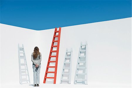 simsearch:632-06118621,k - Businesswoman contemplating ladders, rear view Stock Photo - Premium Royalty-Free, Code: 632-06118330