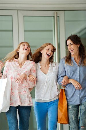 shopping bag woman - Young women walking together, carrying shopping bags Stock Photo - Premium Royalty-Free, Code: 632-06118391