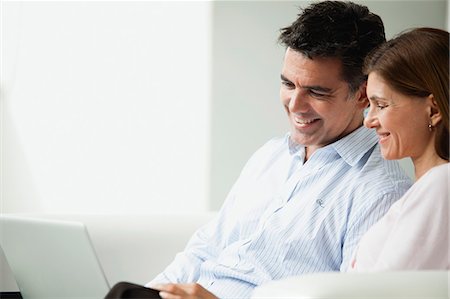 Couple looking at laptop computer together Stock Photo - Premium Royalty-Free, Code: 632-06118393