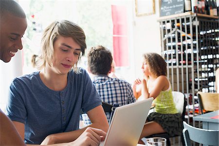 Friends using laptop computer in cafe Stock Photo - Premium Royalty-Free, Code: 632-06118527