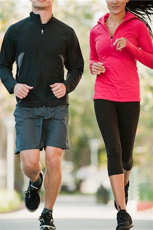 simsearch:632-06118631,k - Couple jogging side by side, cropped Stock Photo - Premium Royalty-Free, Code: 632-06118707