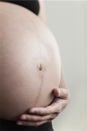 simsearch:632-08227759,k - Pregnant woman's belly Stock Photo - Premium Royalty-Free, Code: 632-06118711