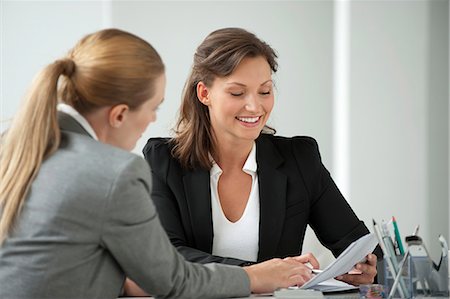 Businesswoman reviewing document with client Stock Photo - Premium Royalty-Free, Code: 632-06118724