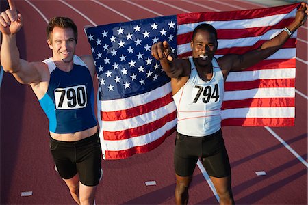 people holding up american flags - Running teammates embracing after race Stock Photo - Premium Royalty-Free, Code: 632-06118837