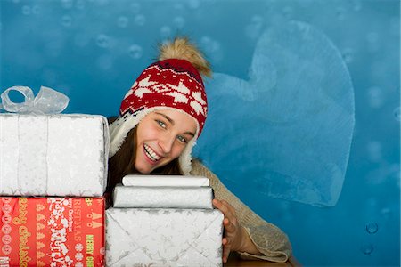 simsearch:649-08969038,k - Young woman with stacks of Christmas gifts, portrait Stock Photo - Premium Royalty-Free, Code: 632-06118906