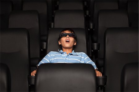 Preteen boy watching 3-D movie in theater Foto de stock - Sin royalties Premium, Código: 632-06118912