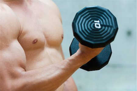 simsearch:632-05759602,k - Man doing bicep curl with dumbbell, mid section Stock Photo - Premium Royalty-Free, Code: 632-06317075