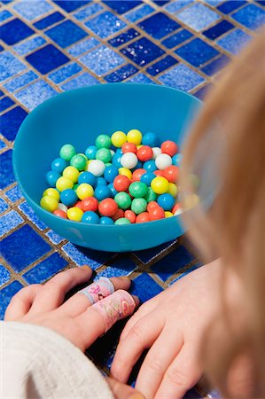 simsearch:632-06317738,k - Little girl contemplating bowl of candy Stock Photo - Premium Royalty-Free, Code: 632-06317196