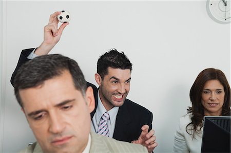 female business woman holding ball - Business people in office, young businessman throwing mini soccer ball Stock Photo - Premium Royalty-Free, Code: 632-06317204
