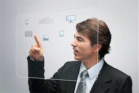 Businessman using cloud computing technology on advanced touch screen interface Foto de stock - Sin royalties Premium, Código: 632-06317207