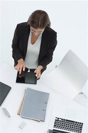 desk directly above - Businesswoman standing by desk using digital tablet Stock Photo - Premium Royalty-Free, Code: 632-06317215