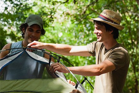 Young men setting up tent in woods Stock Photo - Premium Royalty-Free, Code: 632-06317233