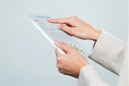 future conceptual - Woman checking email using futuristic digital tablet, cropped Stock Photo - Premium Royalty-Free, Code: 632-06317248